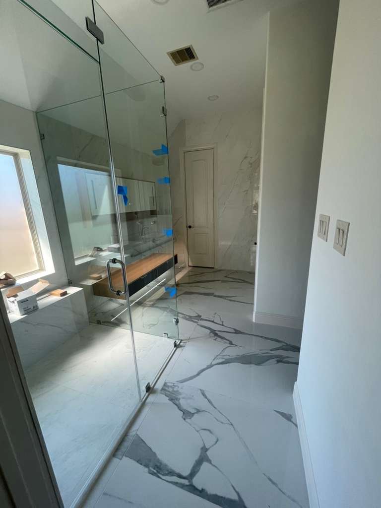Frameless glass shower with marble floor — Spring, TX project