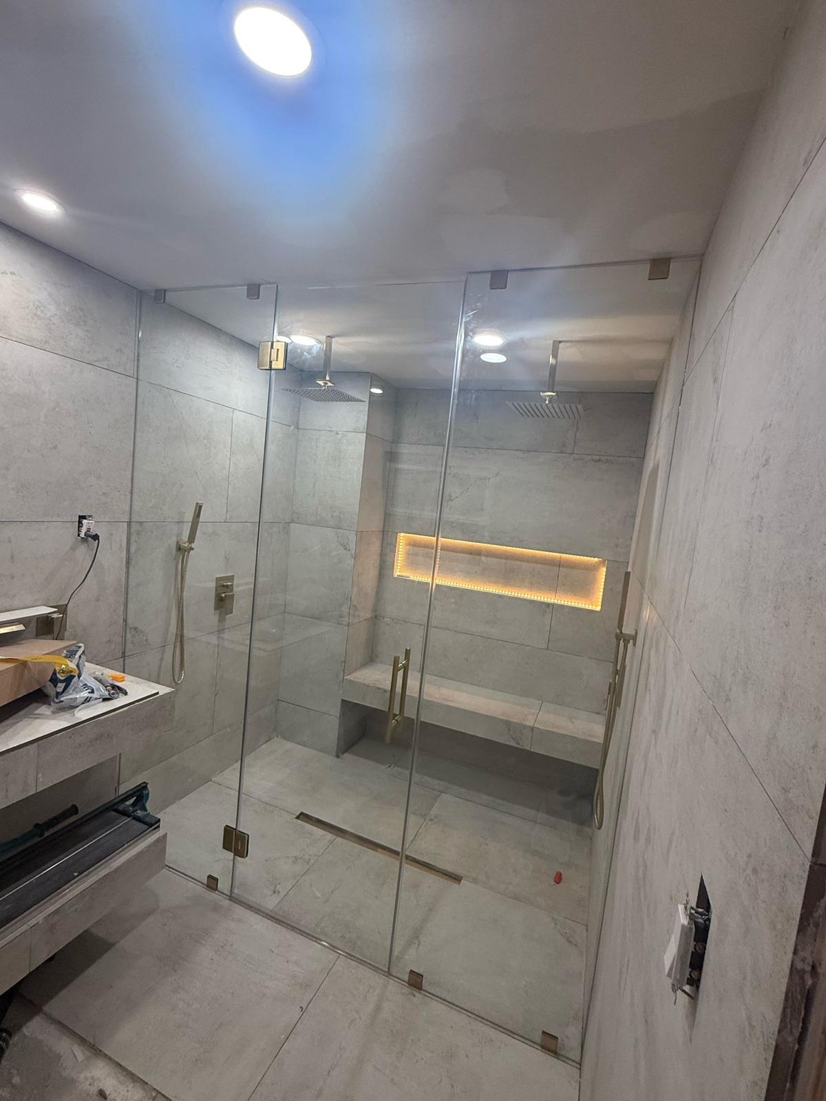 Luxury Glass Shower Enclosure with LED Niche and Gold Hardware - Master Bathroom Houston